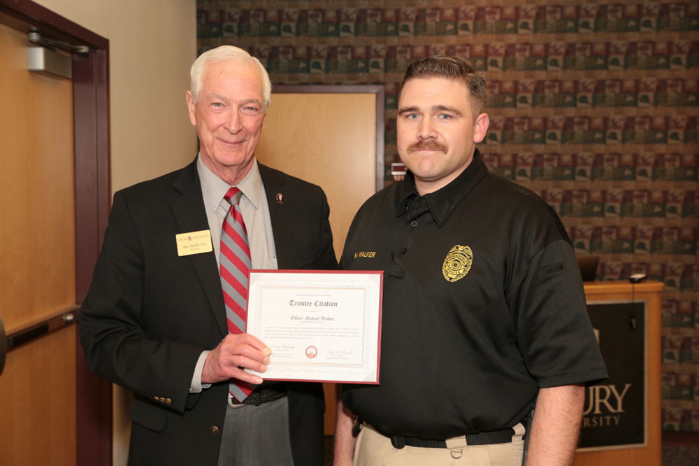 Safety Guru
Drury University trustee Bill Ricketts, left, presents Officer Michael Walker of the Springfield Police Department with a Trustee Citation certificate, recognizing his work to improve campus safety via Crime Prevention Through Environmental Design techniques. Walker is one of two officers assigned full-time to the university.